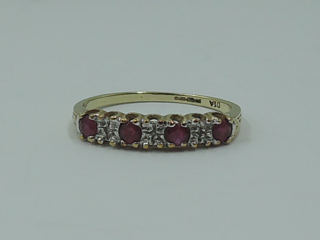 A lady's half eternity ring having four rubies interspersed by diamond chips on a 9ct gold loop,