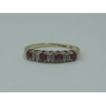 A lady's half eternity ring having four rubies interspersed by diamond chips on a 9ct gold loop,