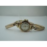 A lady's vintage 9ct gold wrist watch by Leda having a baton and Arabic numeral dial to small face