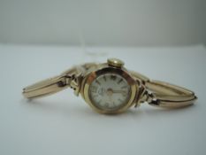 A lady's vintage 9ct gold wrist watch by Leda having a baton and Arabic numeral dial to small face