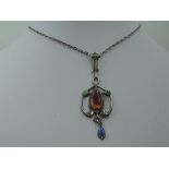 An Edwardian silver pendant of Art Nouveau design having enamelled decoration on a white metal