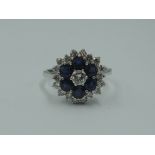 A lady's dress ring having a diamond and sapphire triple cluster, total weights approx 0.80ct