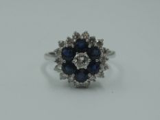 A lady's dress ring having a diamond and sapphire triple cluster, total weights approx 0.80ct