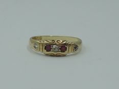 A lady's 18ct gold band ring having rubies and diamonds inset in a moulded mount, size N