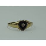 A 9ct gold signet ring having a heart shaped onyx panel with diamond chip inset, size R & approx 1.