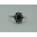 A lady's dress ring having an oval sapphire and diamond chip cluster on a 9ct gold loop, size N