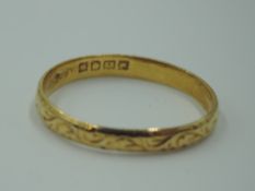 A 22ct gold wedding band having engraved scroll decoration, size V & 3.2g