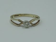 A lady's diamond solitaire dress ring, approx 0.128ct in a claw set mount to open shoulders on a 9ct