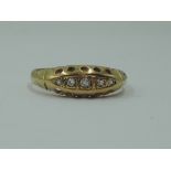 A lady's dress ring having five graduated diamond chips in a gallery mount on an 18ct gold loop,