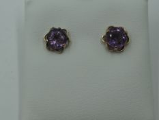 A pair of amethyst stud earrings in 9ct gold mounts