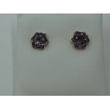 A pair of amethyst stud earrings in 9ct gold mounts