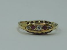 A lady's dress ring having two rubies interspersed by three diamond chips in a gallery mount on a
