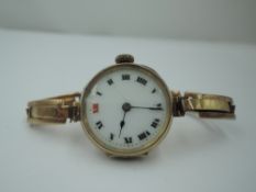 A lady's vintage 9ct gold wrist watch having a Roman numeral and gilt dot dial to circular face in a