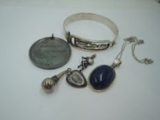 An Egyptian silver tension bangle having decorative panel, a silver medal, Lapis Lazuli pendant in