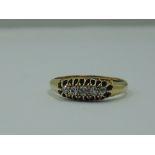 A lady's dress ring having five graduated old cut diamonds in a pierced gallery mount on an 18ct