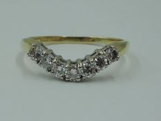 A lady's shaped half eternity ring having seven diamonds, total approx 0.35ct in a curved claw set