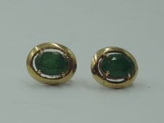 A pair of 9ct gold stud earrings having jade style oval stones