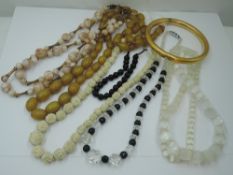 A small selection of vintage strings of beads including carved bone, crystal and jet, carved