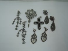 A silver pendant/brooch having marcasite and seed pearl decoration with matched similar earrings,