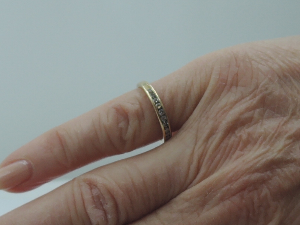 A lady's half eternity ring having ten chanel set diamond chips on a yellow metal loop stamped - Image 2 of 2