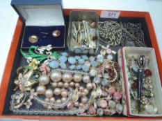 A small selection of vintage costume jewellery including brooches, watch chains, clip earrings,