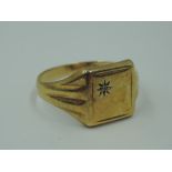 A gent's 9ct gold signet ring having an inset diamond chip to square panel, size V & approx 3.2g