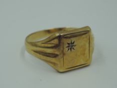 A gent's 9ct gold signet ring having an inset diamond chip to square panel, size V & approx 3.2g