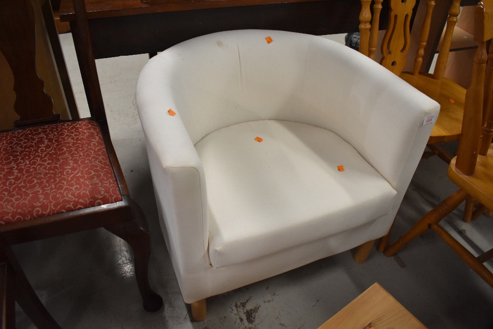 A modern low cream upholstery tub chair