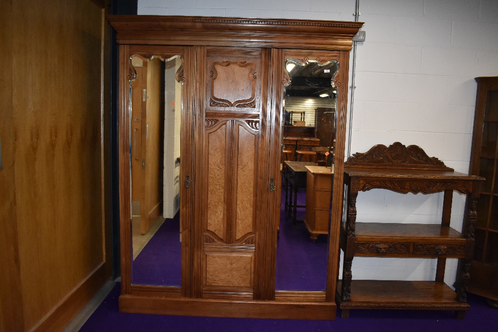 A late Victorian or Edwardian triple wardrobe, two doors being mirrored, possibly later lined,