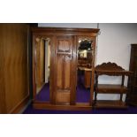 A late Victorian or Edwardian triple wardrobe, two doors being mirrored, possibly later lined,