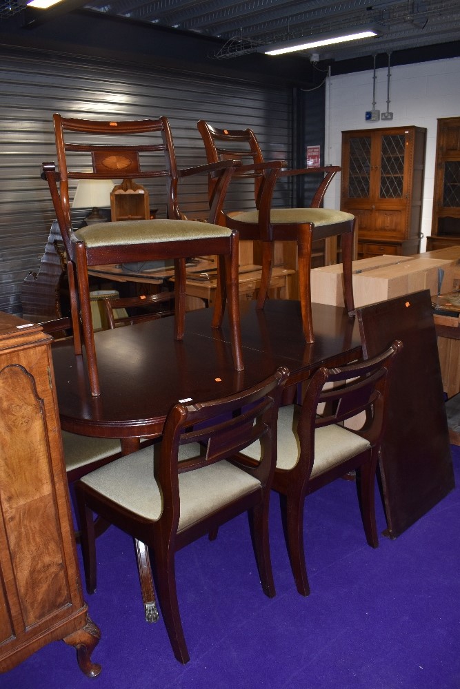 A reproduction Regency dining table and six (four plus two) chairs