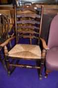 A traditional rush seated ladderback rocking chair