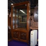 An early 20th Century oak display cabinet, having side opening doors, and cupboard base, width