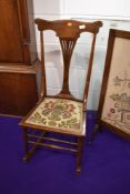 An Art Nouveau stained frame bedroom rocking chair