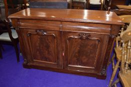 A Victorian mahogany sideboard, having two shaped semi concealed frieze drawers over double