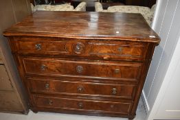 A late Victorian chest of four drawers having flame mahogany front with beaded fronts on bun feet