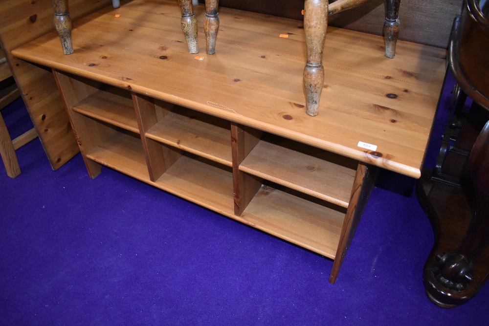 A modern pine coffee table, having under shelves, approx. 120 x 60cm