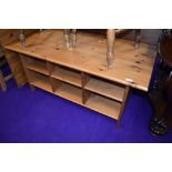 A modern pine coffee table, having under shelves, approx. 120 x 60cm