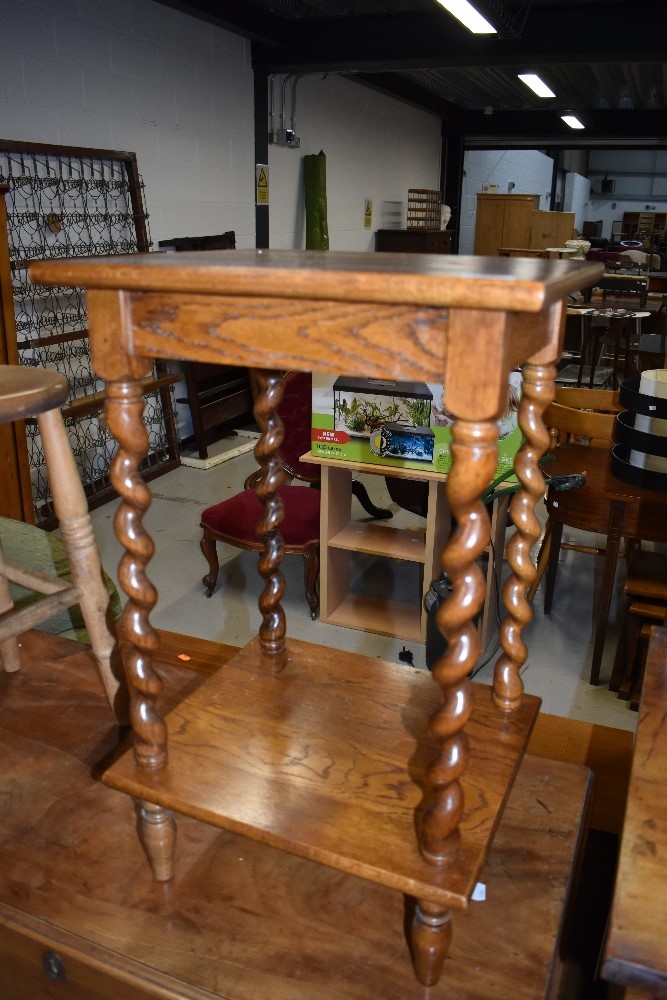 An Edwardian side or hall telephone table having twisted legs with solid oak frame
