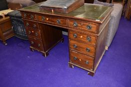 An early 20th Century mahogany pedestal desk, approx. 124 x 60cm, feet very worn, possibly chewed?