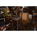 An Edwardian steam bent wood chair having decorated seat