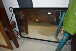 A metal framed wall mounted mirror