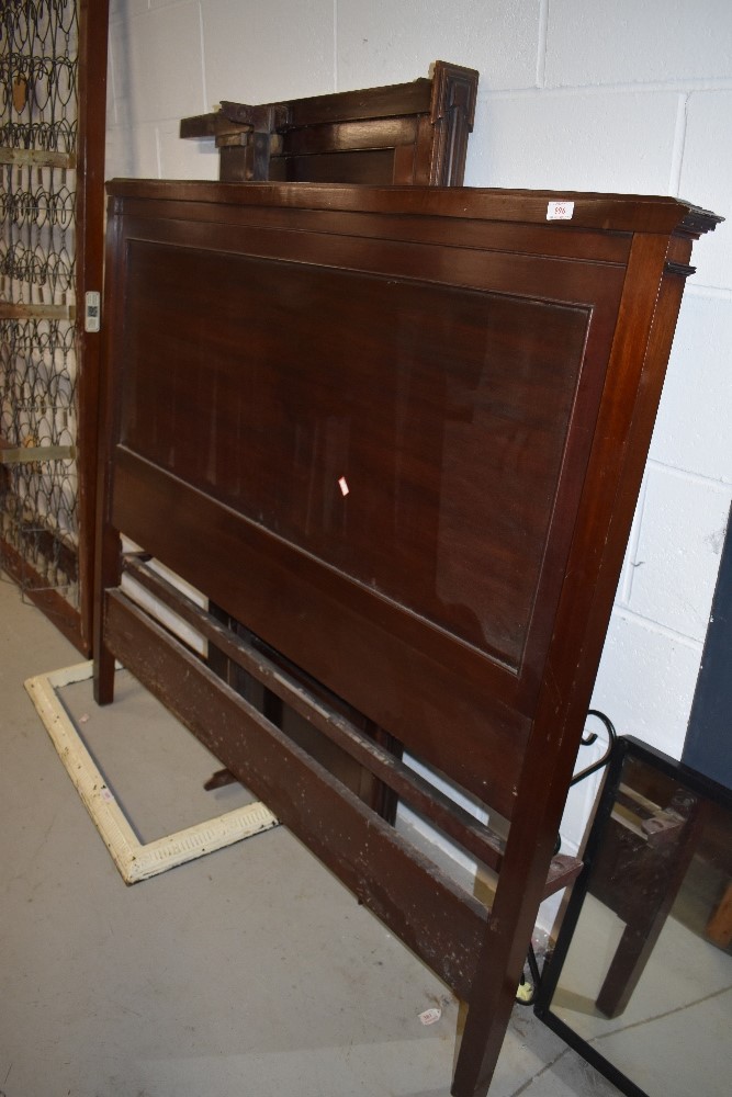 A late 20th Century mahogany pannelled bed frame including side irons and base, approx width 137cm