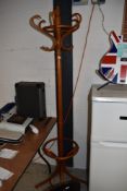 A steamed wood light stained cloak or coat stand