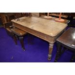 A traditional stripped oak library table on reeded legs, approx. 153 x 77cm, split to top