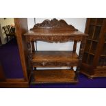 A traditional oak buffet sideboard having frieze drawers to undershelf with carved 'Greenman'