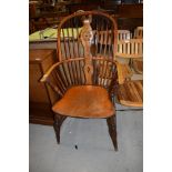 A traditional antique elm seated and steamed ash bow back Windsor chair having wheeled vase back