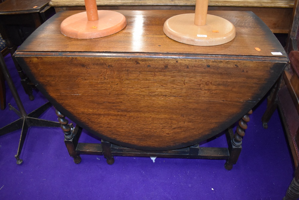 An early to mid 20th Century oak twist gate leg table, width approx. 107cm