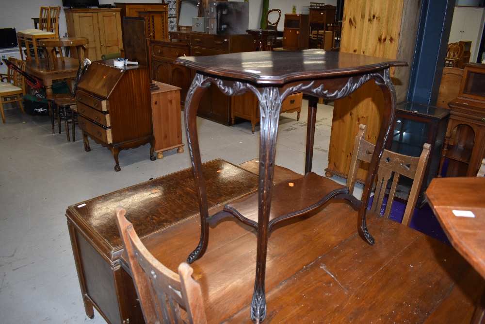 A 1920s mahogany occasional table having shaped top and undertier, width approx. 70cm