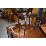 A 1920s mahogany occasional table having shaped top and undertier, width approx. 70cm